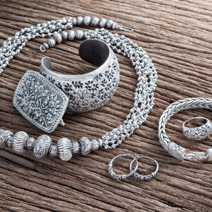 Collection of antique traditional silver jewelry on old wood